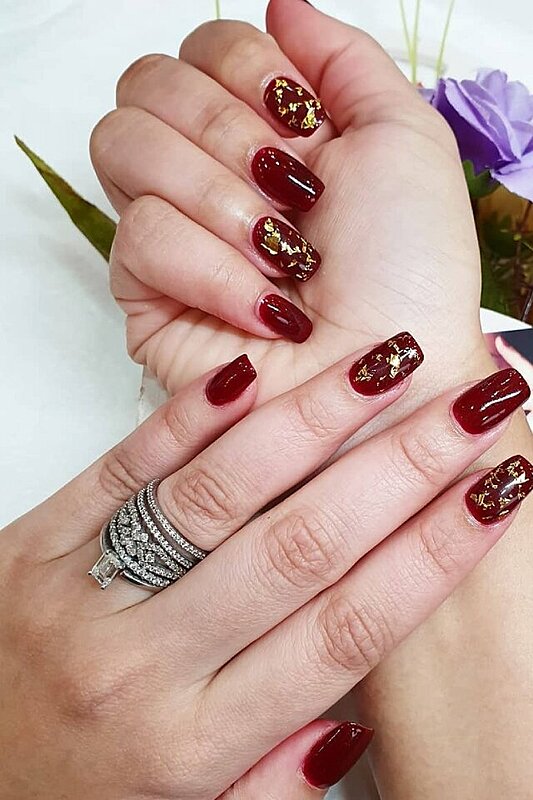 Closeup woman hand with burgundy red nail polish on fingernails. Burgundy  nail manicure with gel polish at luxury beauty salon. French manicure. Nail  art and design. Female hand model. Generative AI. 32087662